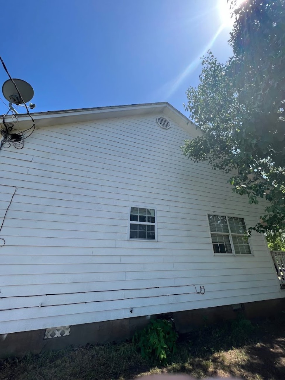 Clean white house siding after pressure washing — Arlington, TX
