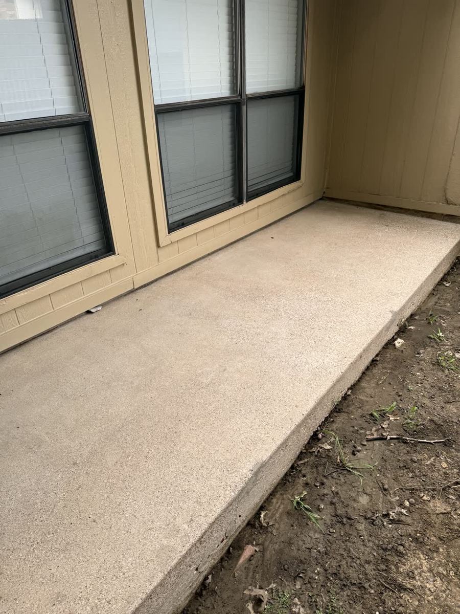 Clean restored concrete walkway after pressure washing — DFW area