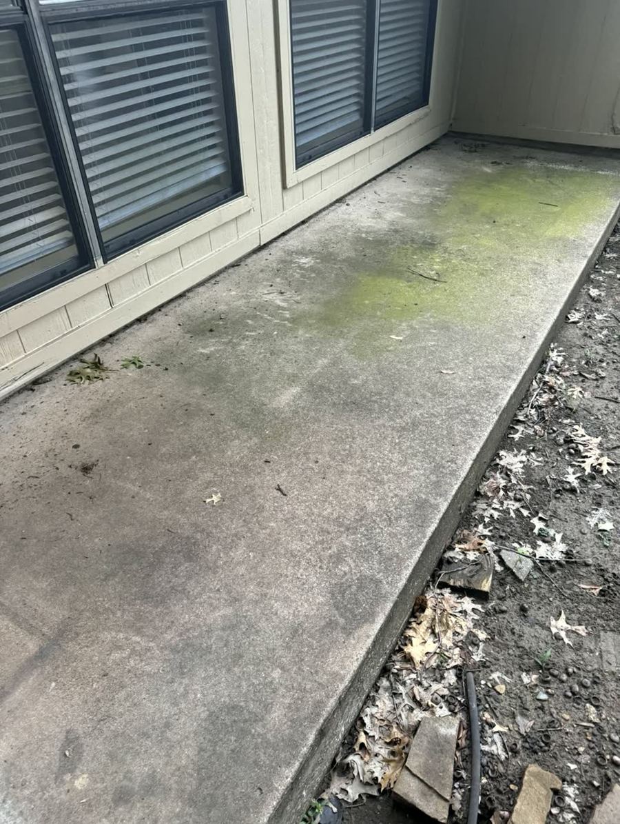 Apartment walkway covered in green algae and grime before pressure washing — DFW area