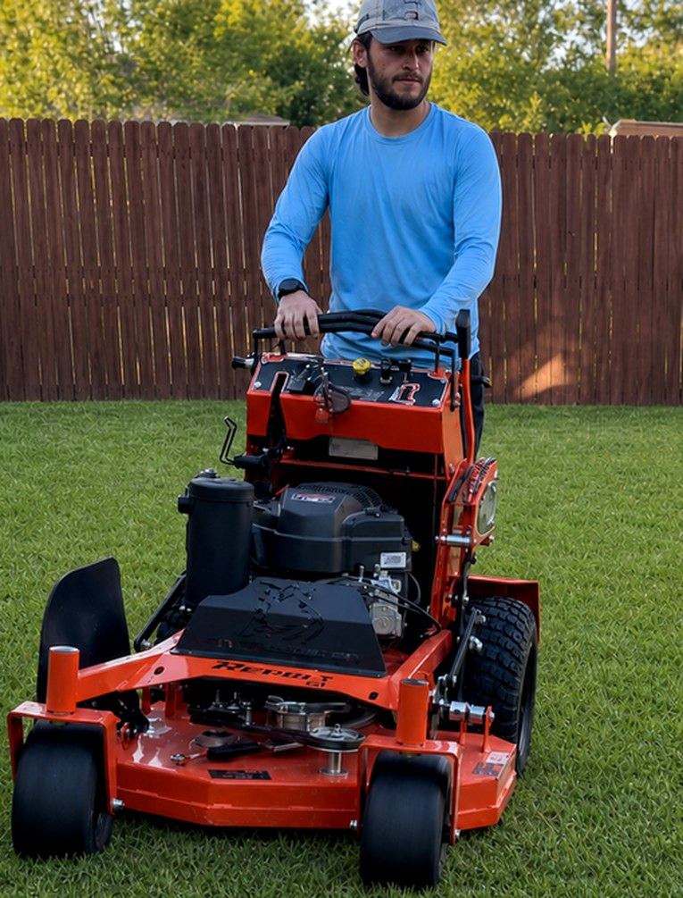 Victor Zertuche with his stand-on mower in an Arlington, TX backyard — owner of Zertuche Pro Solutions